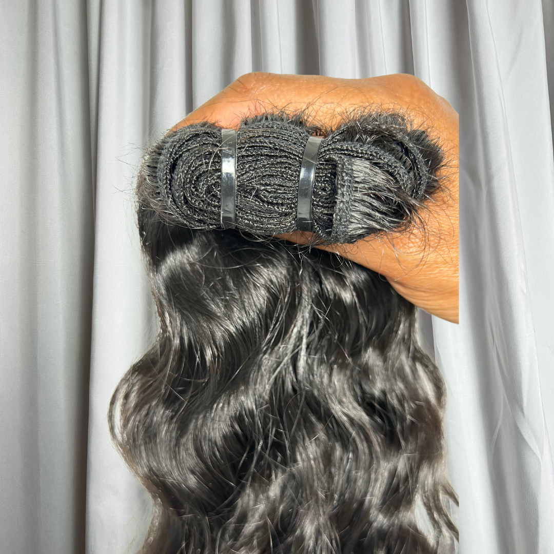 Close up of weft on wavy Raw Indian hair extensions
